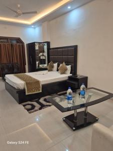 a bedroom with a bed and a table with two water bottles at Hotel Umang in Sītāmarhi