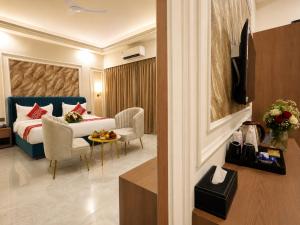 a hotel room with a bed and a table and chairs at Vijay Vilas by Arow Hotels and Resorts in Pushkar