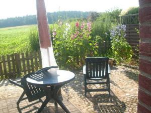 a table and two chairs sitting on a patio at Ferienwohnung Ziebell in Bollewick