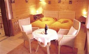 a bedroom with a bed and a table and chairs at Appartements Wörgötter Astrid & Sepp in Rettenbach
