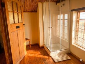 a room with a shower and a glass door at Route 62 B&B in Robertson +60 photos