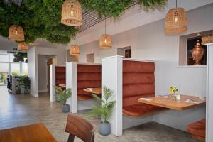 a restaurant with tables and chairs and pendant lights at White House in St Asaph +26 photos