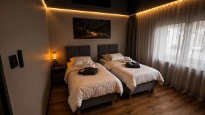 two beds in a bedroom with two bags on them at M&M Apartment Air Conditioning Garage in Adenau