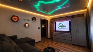 a living room with a couch and a flat screen tv at M&M Apartment Air Conditioning Garage in Adenau