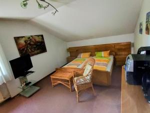 a small bedroom with a bed and a television at Ferienwohnung Zöller Villmar in Villmar