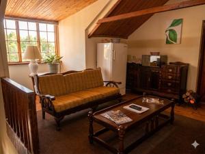 a living room with a couch and a table at Route 62 B&B in Robertson