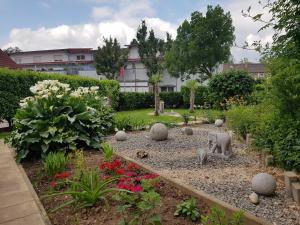 a garden with rocks and flowers in a yard at Gästehaus Schwien in Rust