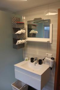 a bathroom with a sink and a mirror and towels at Gästehaus Schwien in Rust +14 photos