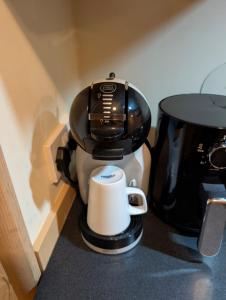 a coffee maker sitting on a counter next to a coffee pot at Shore&Meadow Holiday Lets - Luxury 8 berth caravan at Regent Bay in Morecambe
