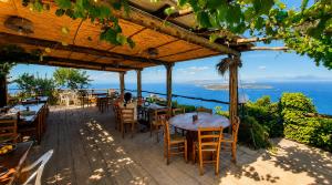 a restaurant with tables and chairs and a view of the ocean at Campagnano Rural Suite & Spa in Ischia Town