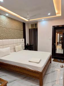 a bedroom with a large white bed in a room at Hotel Umang in Sītāmarhi