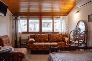 a living room with a couch and a window at Valchevi Apartments in Chernomorets