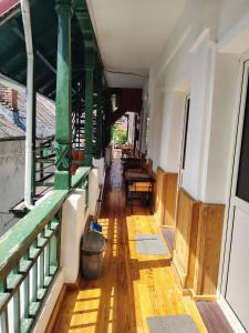 a hallway of a building with wooden floors and green railing at Casa Olanescu in Băile Olăneşti