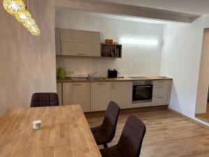 a kitchen with a table and chairs in a room at Ferienwohnung Seestern-Mondsee in Unterach am Attersee