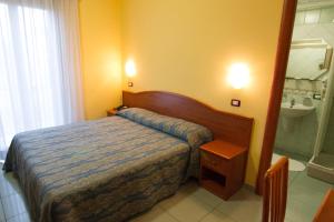 Giường trong phòng chung tại Pensione Al Pescatore