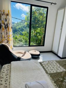 a room with a bed and a large window at Lavenia Mountain Holiday home in Bandarawela