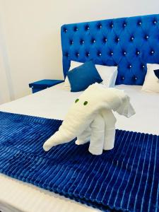 a stuffed elephant is sitting on a bed at Lavenia Mountain Holiday home in Bandarawela