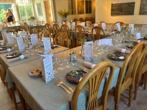 a long table with plates of food and wine glasses at Blankaholms Gästgiveri in Blankaholm +22 photos