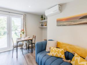 a living room with a blue couch and a table at Kingsleys Lodge in Barnstaple