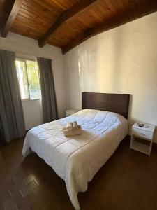 a bedroom with a bed with two towels on it at Casa YRIGOYEN in Junín