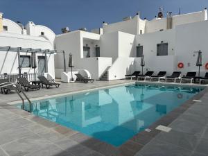 a swimming pool on the side of a hotel at Tarelis Beach Apartments & Studios in Kamari