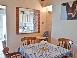 a dining room with a table and a mirror at No 2 Flowery Bank in Malton