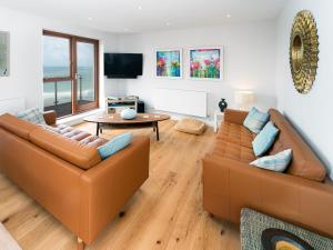 a living room with two couches and a table at Sunset Beach - Uk42994 in Woolacombe