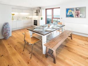 a kitchen and dining room with a table and chairs at Sunset Beach - Uk42994 in Woolacombe