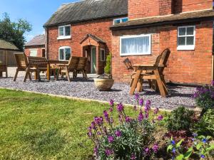 a group of chairs and tables in front of a house at Brynfields in Ashbourne +23 photos