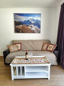 a living room with a couch and a table at Residence Mariagrazia - Kärnten Card im Sommer inklusive in Bad Kleinkirchheim +70 photos