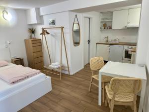 a room with a bed and a table and chairs at Alpine Echo Apartments in Bovec