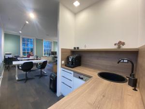 an office with a kitchen with a sink and a desk at Gulfhof Friedrichsgroden in Carolinensiel +43 photos