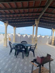 a table and chairs on a patio with a view at Perle de Soliman Plage in Soliman +19 photos