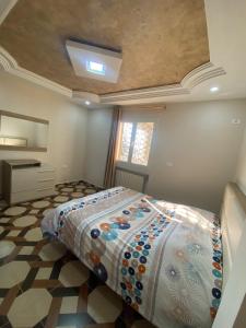 a bedroom with a bed with a colorful comforter at Perle de Soliman Plage in Soliman