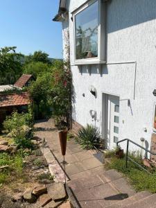 a white building with a window and a patio at Ferienwohnung in Hannoversch Münden