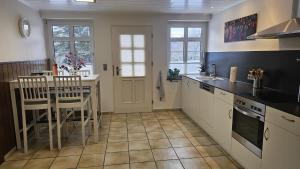 a kitchen with a table and chairs and a counter top at Ferienwohnung Wennetal in Schmallenberg +28 photos