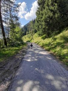 a person is walking down a road at Haus Peintner in Tannheim