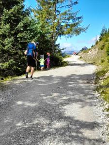 a man and two children walking down a road at Haus Peintner in Tannheim +54 photos