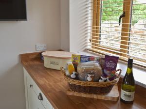 a basket of food and a bottle of wine on a counter at The Granary in Pendleton