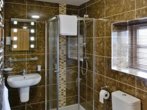 a bathroom with a shower and a sink and a toilet at The Granary in Pendleton +7 photos