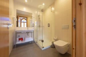 a bathroom with a shower and a toilet at Casa da Baixa by PURUS in Coimbra +43 photos