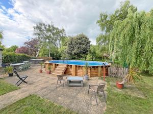 a patio with a swimming pool in a yard at Abbott's Farm in Horbling