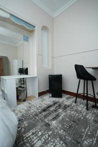 a room with a black chair and a mirror at Castle hostel in Cairo