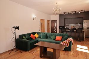 a living room with a green couch and a table at Balcony in Shatin