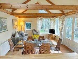 a living room with a table and chairs at Garrique Cottage in Kippen