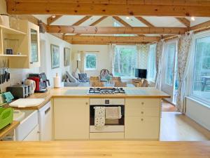 a kitchen with an island with a stove top oven at Garrique Cottage in Kippen