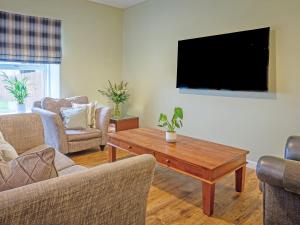 a living room with a tv and a coffee table at Easter Caiplich - Uk30263 in Cray
