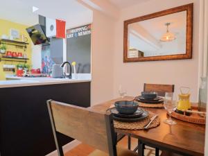 a dining room with a table and a mirror at 6 Bedford Place in Bridport