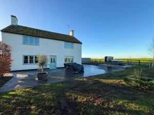 a white house with a patio in front of it at Hill House - Uk49727 in King's Lynn