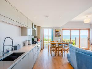 a kitchen and dining room with a table and chairs at Beachbreak - Uk42996 in Woolacombe